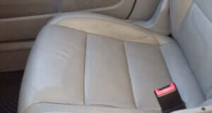 Water damage to light leather car seats.